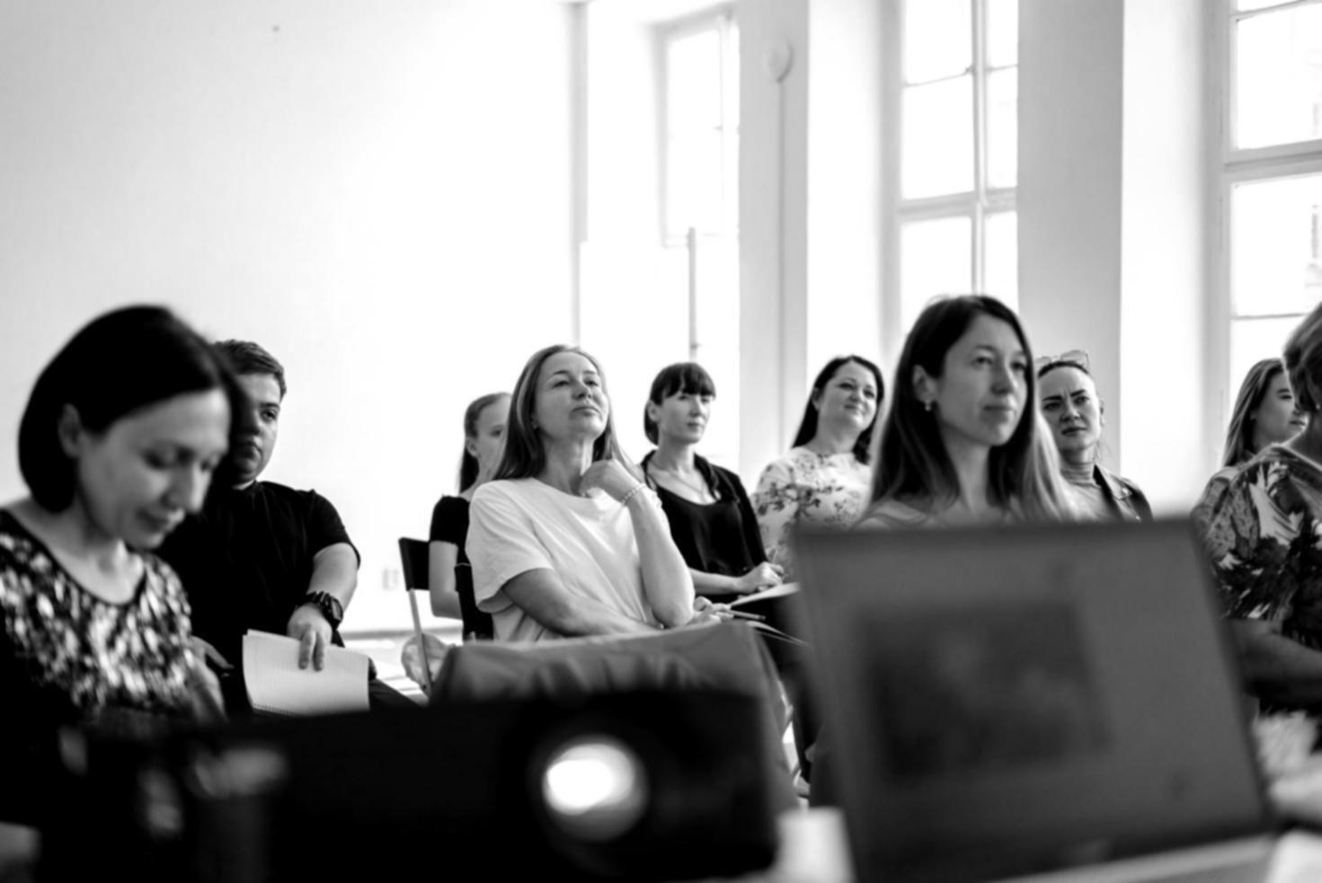 Interactive workshop session with participants reviewing personal financial documents and savings strategies